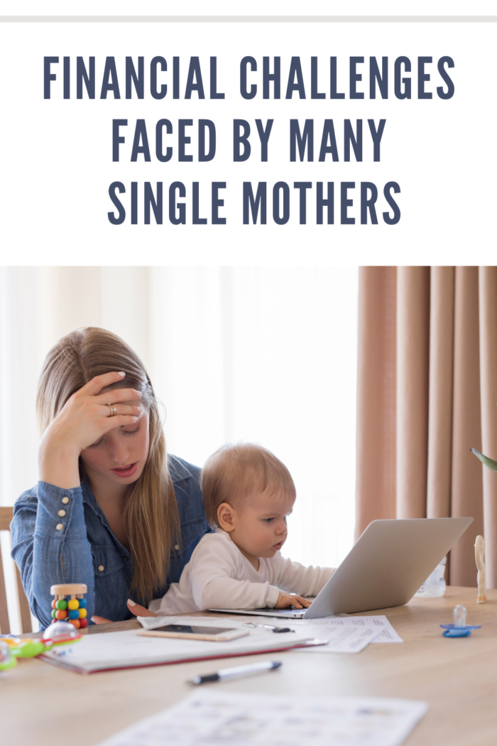 single mom budgeting with baby on lap