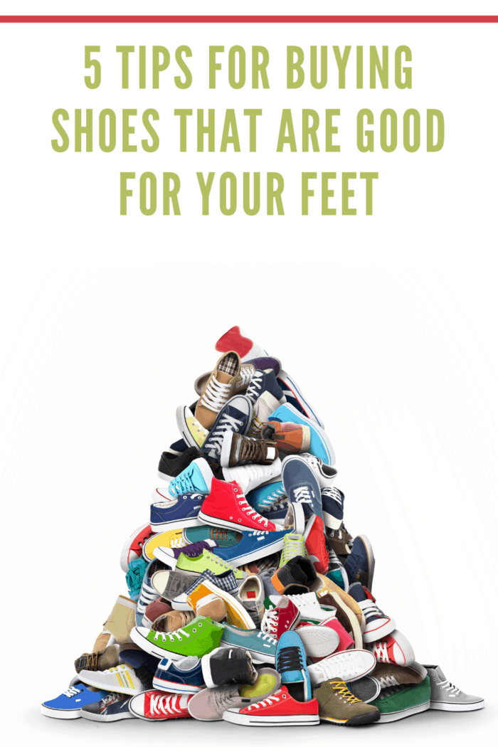 A very large pile of athletic shoes on white background