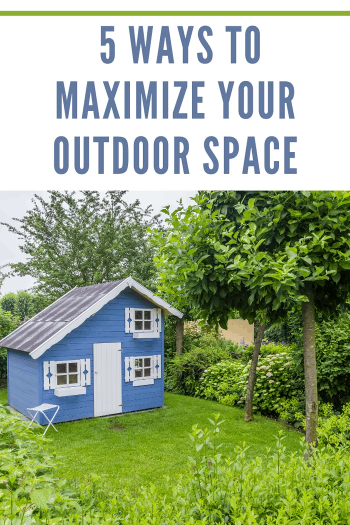 Cozy little blue playhouse in a green garden