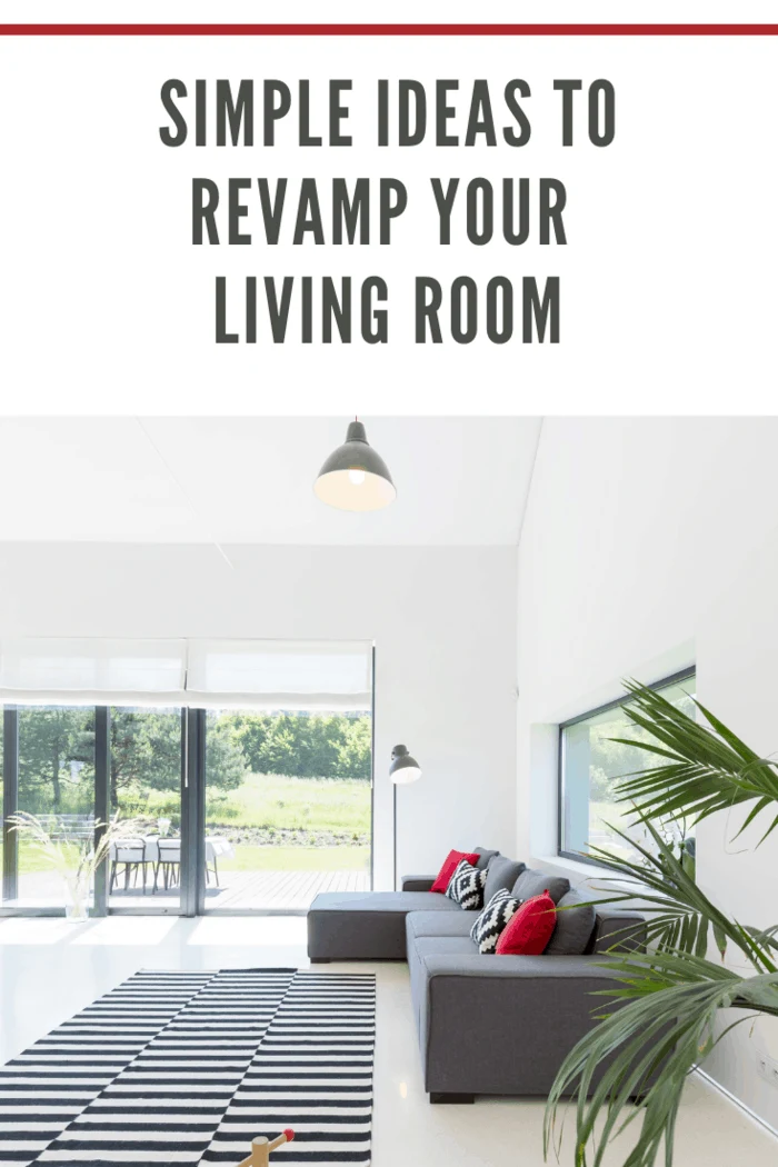 White living room with window wall, sofa, pattern carpet