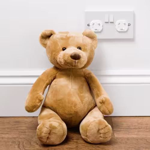 Teddy bear and childproof outlet