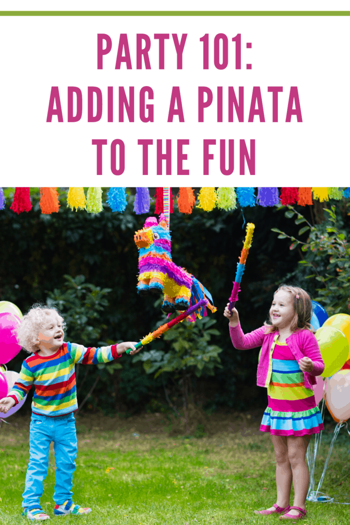 boy and girl taking turns trying to break the pinata open