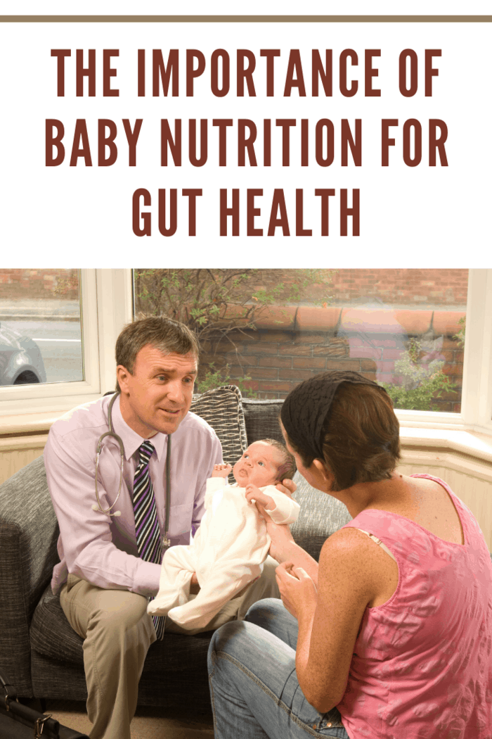 visiting doctor gives baby the all clear and discusses the importance of baby nutrition for gut health with mother