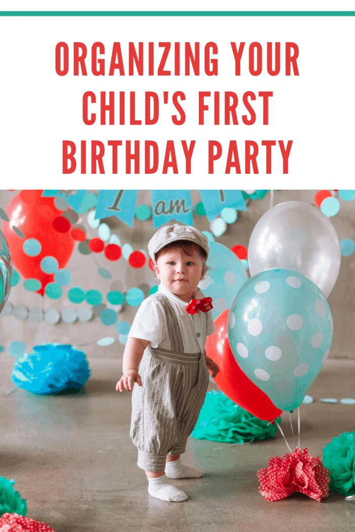 Festive background decoration for birthday celebration with boy in crown and teal, red and blue decorations and balloons in background