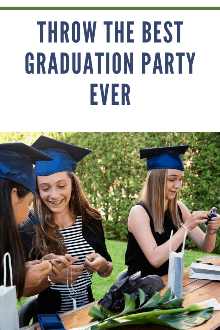 Celebrating middle school graduation in the backyard three multi-ethnic teenage girls.They are opening gifts wearing their graduation hats sitting on terrasse. Horizontal outdoors waist up shot with copy space.