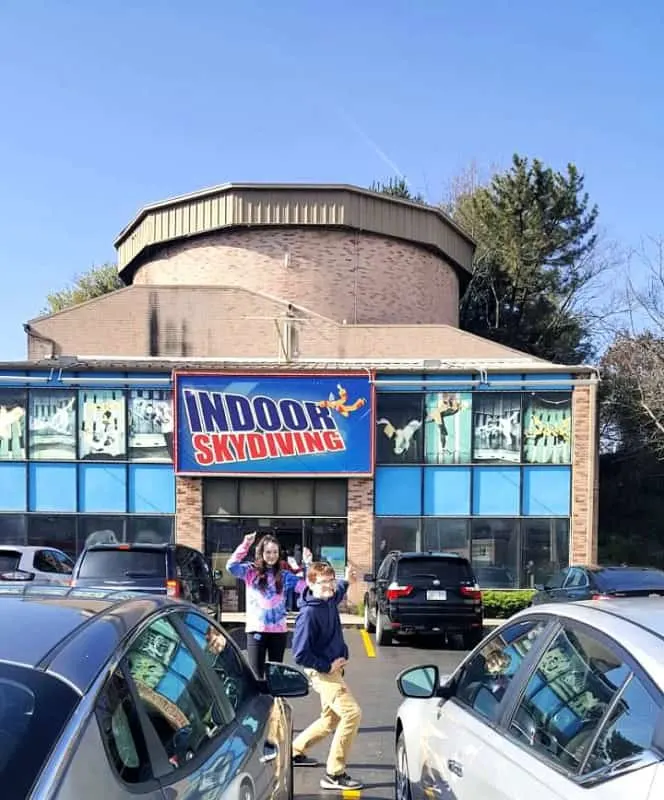 Kids excitedly posing outside Flyaway Indoor Skydiving in Pigeon Forge