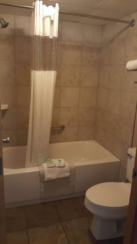 Bathroom at Willow Brook Lodge in Pigeon Forge with a full-size bathtub, shower, and modern tile design.