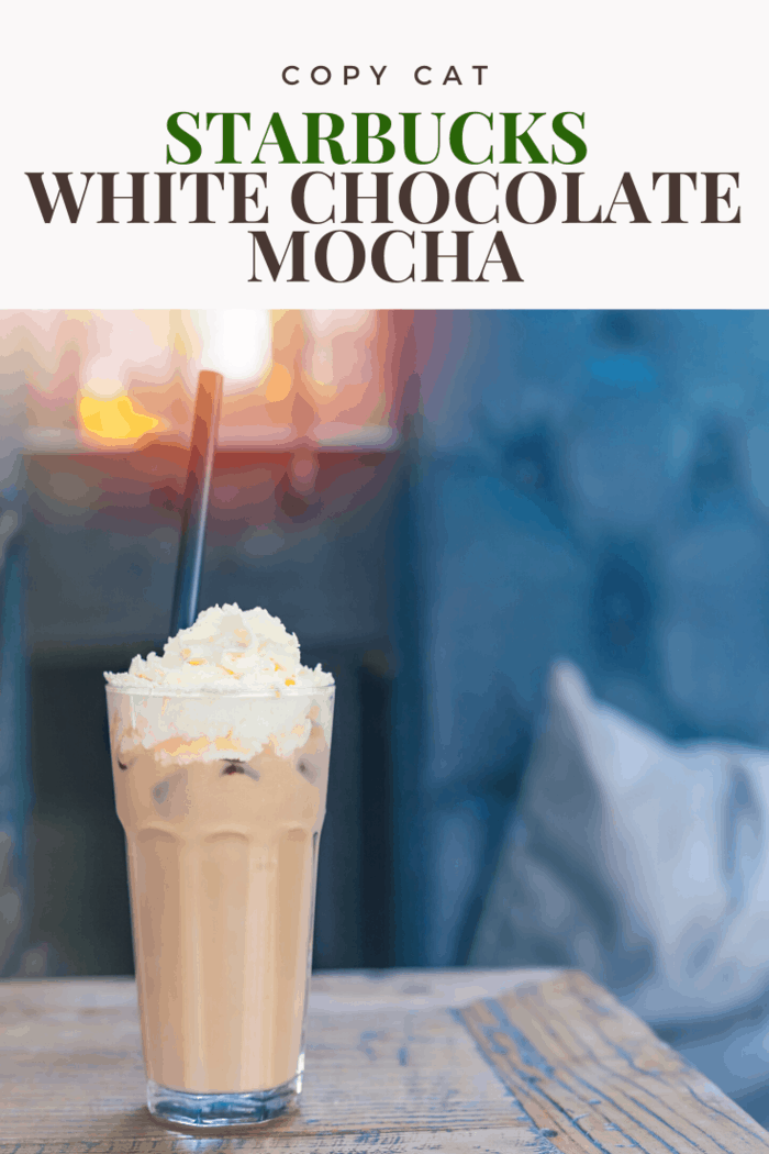 Starbucks white chocolate mocha on table with straw and whipped cream