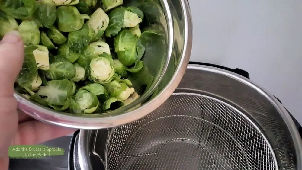 add the seasoned brussels sprouts to the mesh basket