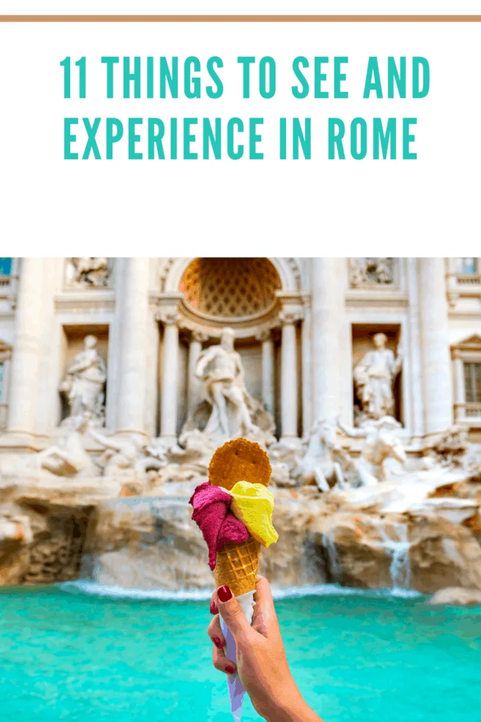 Hand holding colorful gelato in front of famous iconic Trevi Fountain at Rome, Italy.