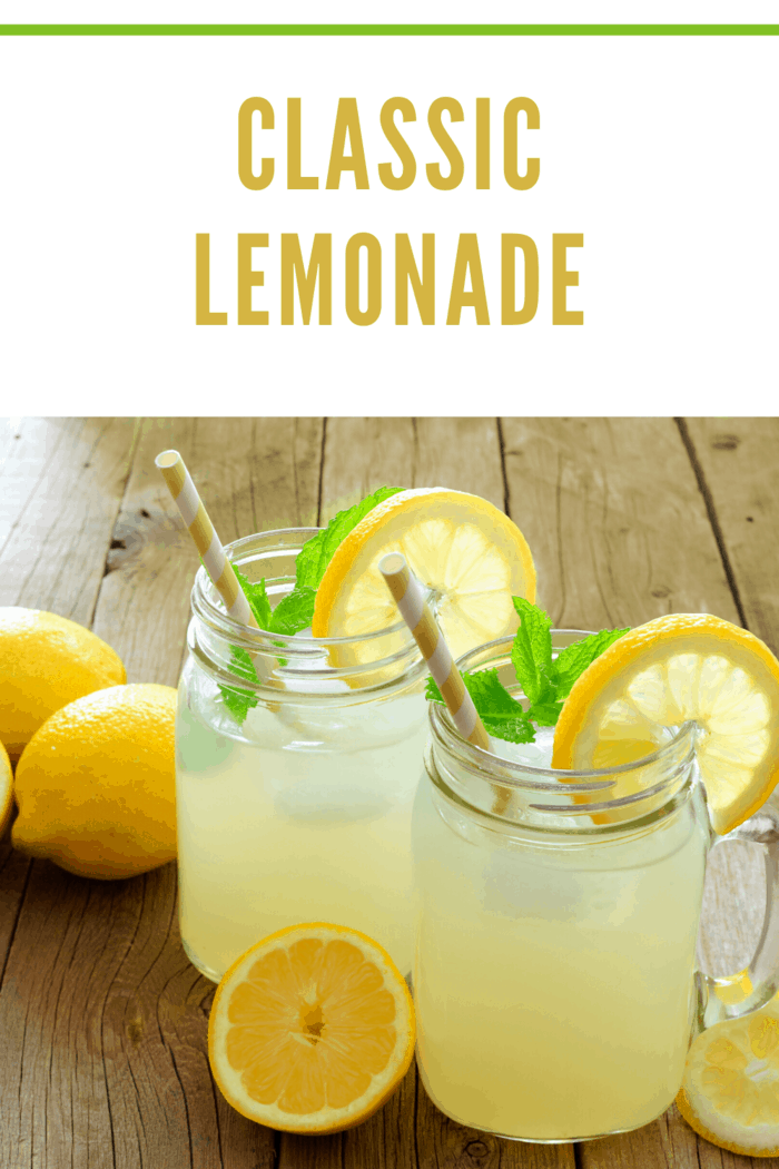 Two mason jar glasses filled with classic lemonade and garnished with lemon slices, perfect for summer