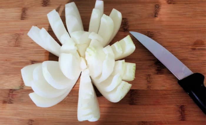 onion cut into sections for onion bloom