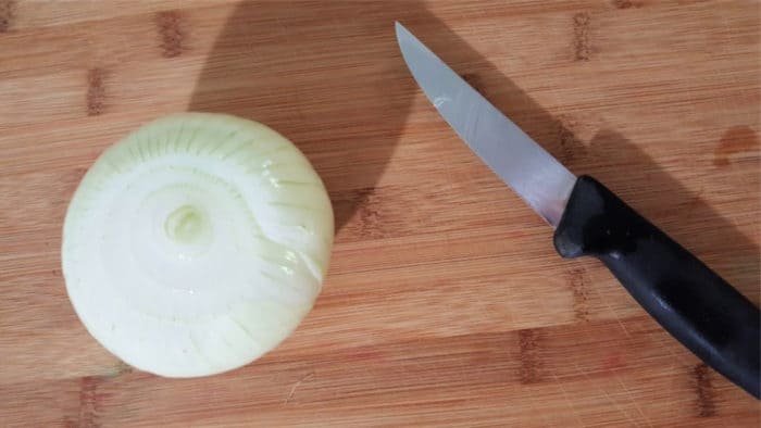 onion on cutting board with knife