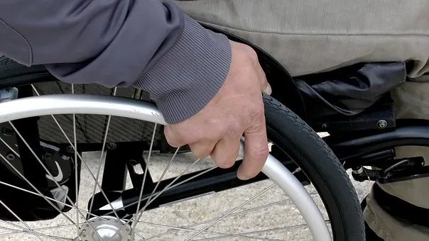 man in electric wheelchair watching sun set