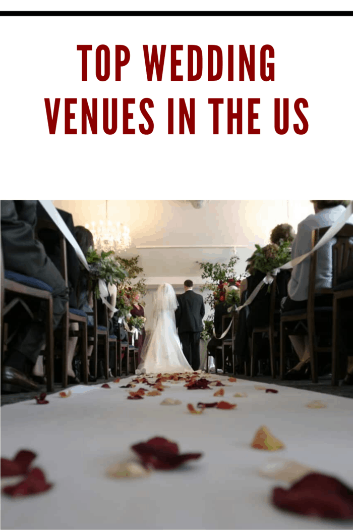 bride walking down the aisle at wedding venue with rose petals scattered