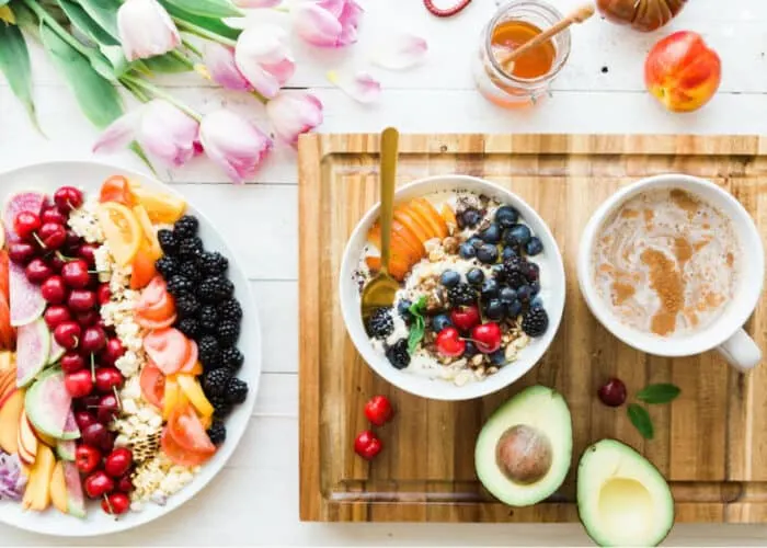 Avocado, berries, and keto-approved foods perfect for a postpartum weight loss meal plan on the keto diet.