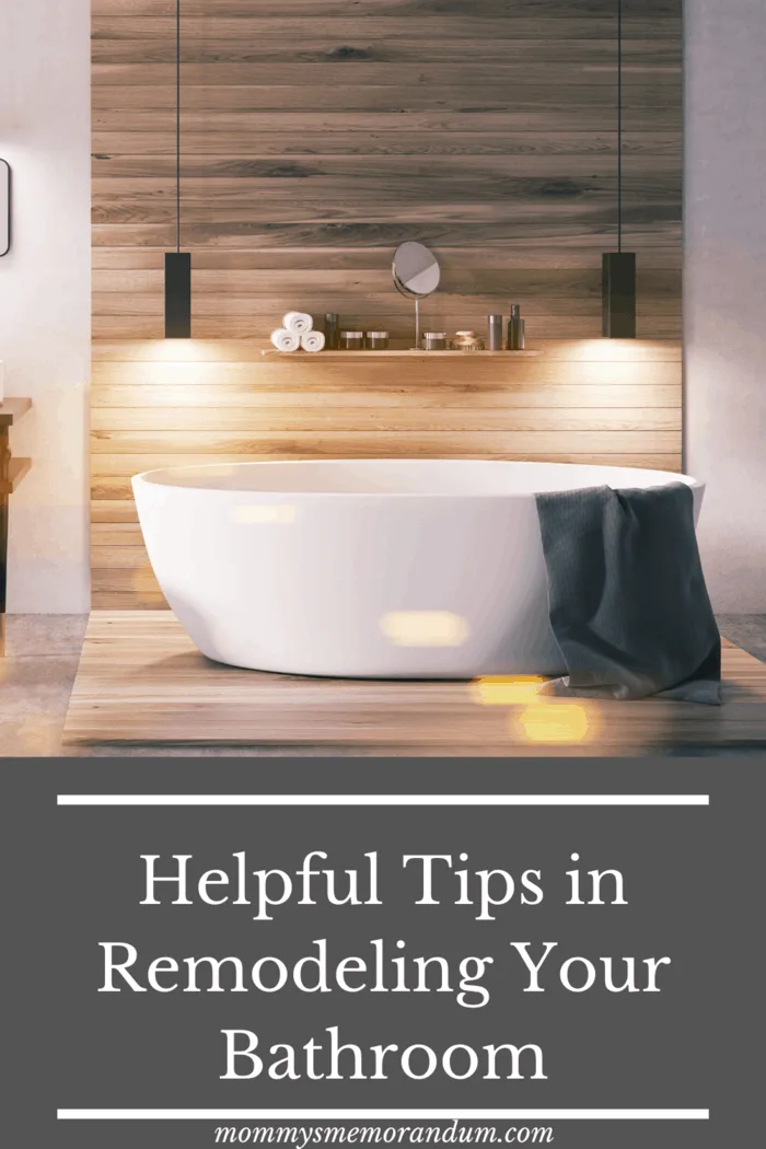 large soaking tub against teakwood slated wall with hanging lights