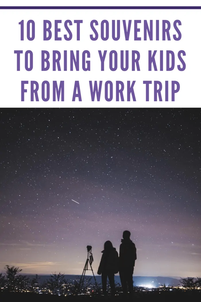 father and child looking at night sky through telescope