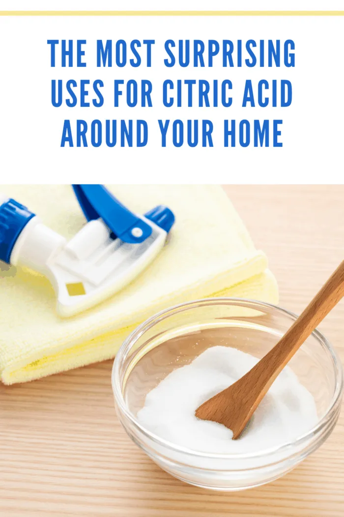 Citric acid in bowl on table, with towel and spray bottle ready for cleaning