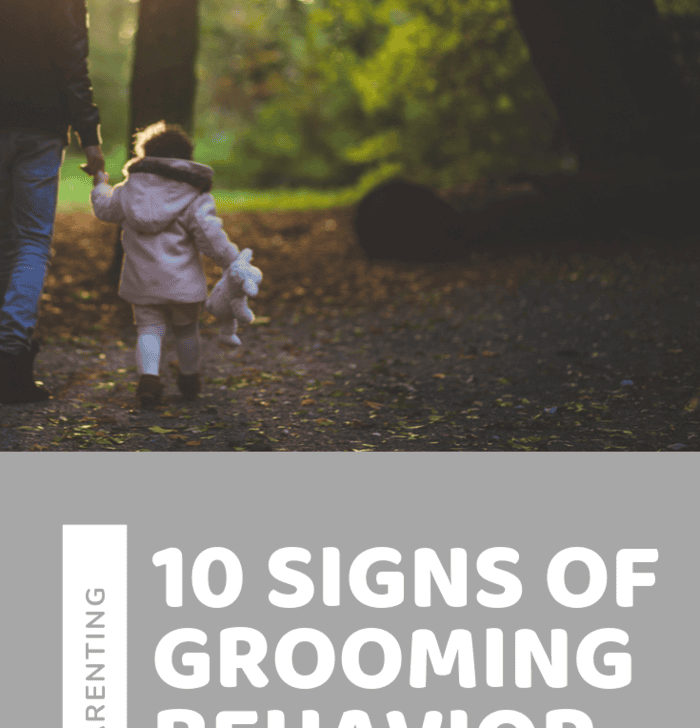 Groomer holding small child's hand, stuffed animal in child's other hand, walking away