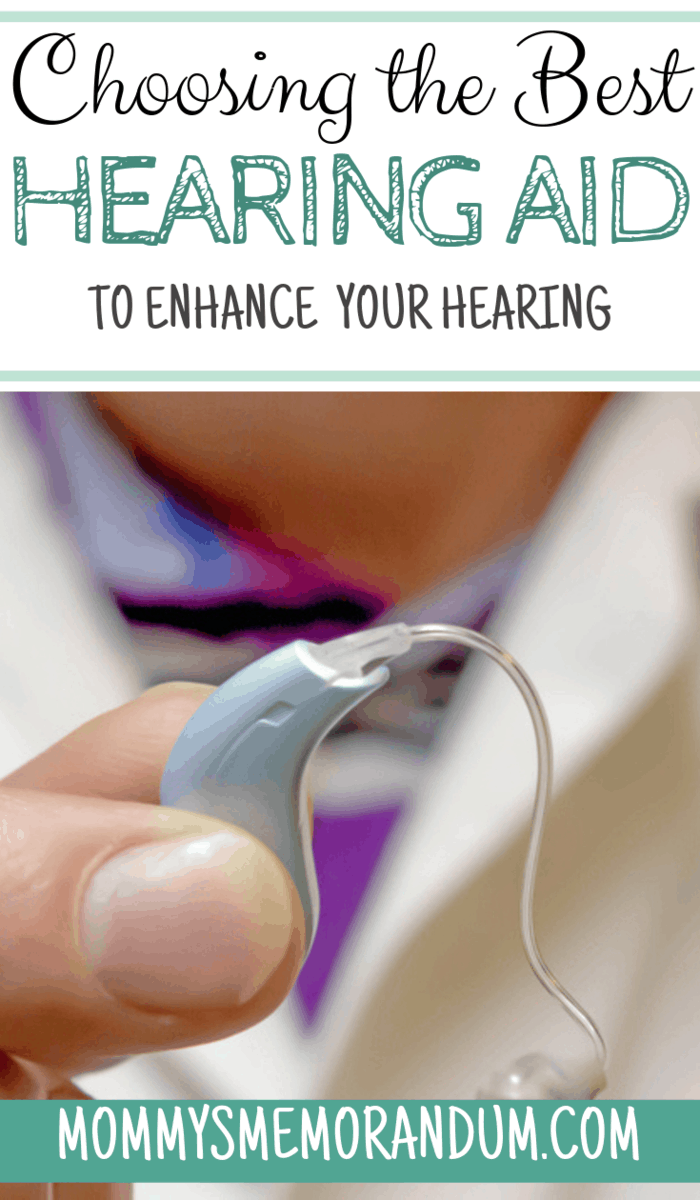 Behind the ear hearing aid being held by an audiologist
