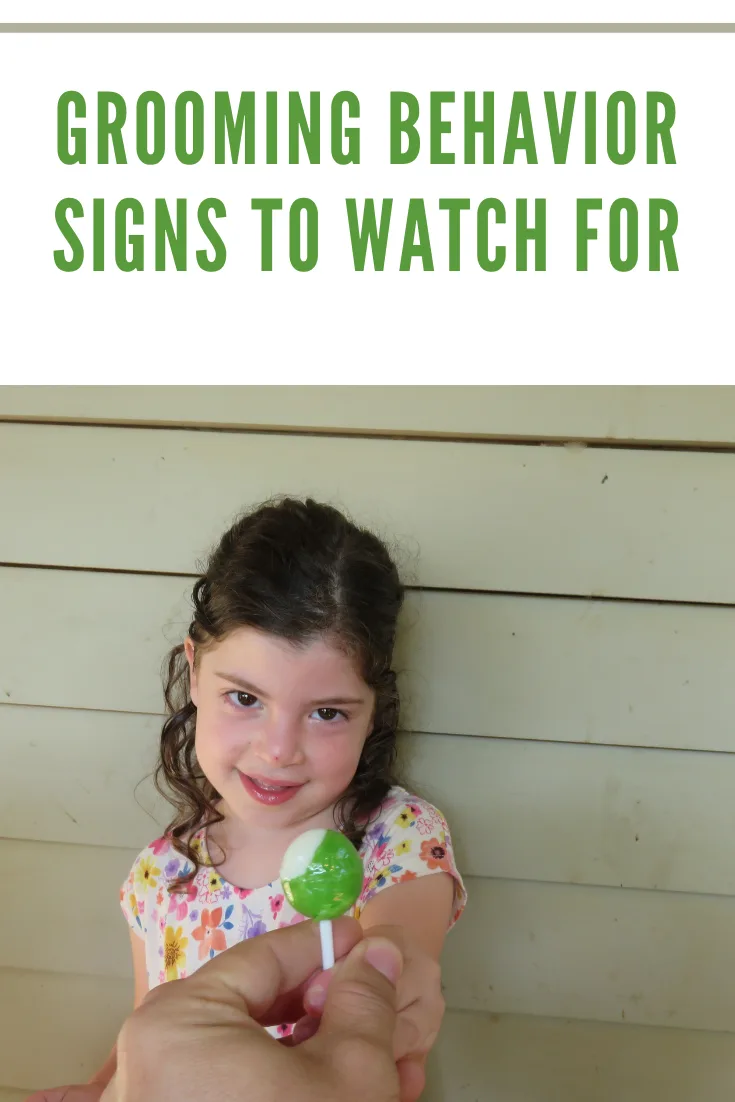 little girl being gifted green sucker