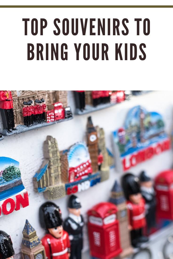 A display of colorful London-themed souvenir magnets including red buses, black cabs, and iconic landmarks.