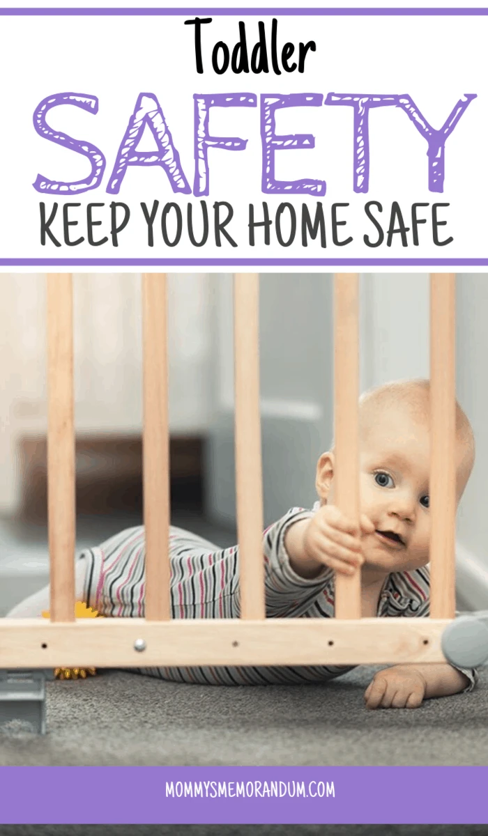 child holding bar of safety gate