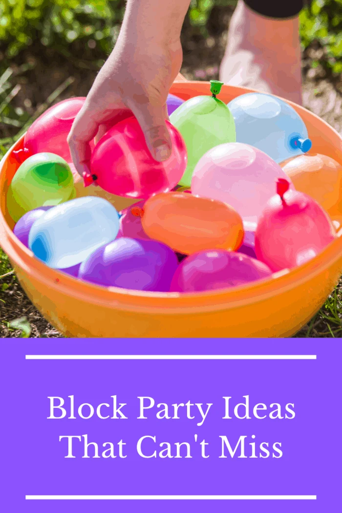 Hand picking colorful water balloons for a block party activity