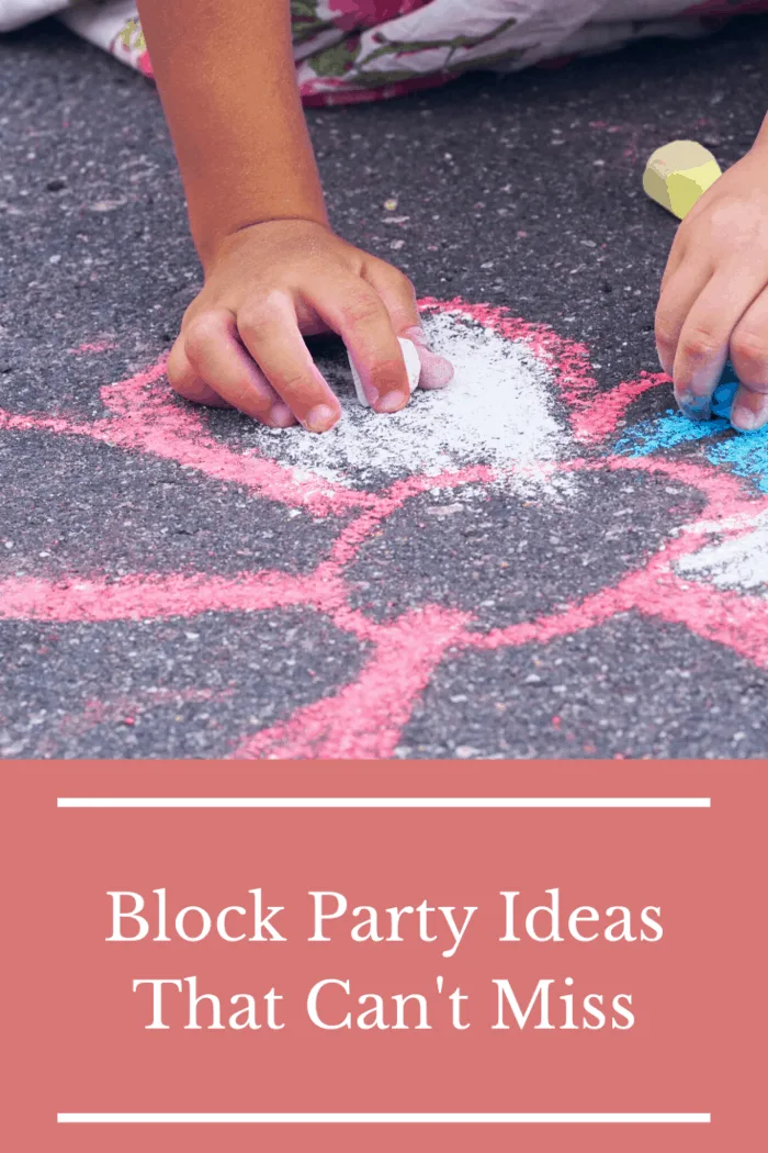 Child drawing with sidewalk chalk at a block party