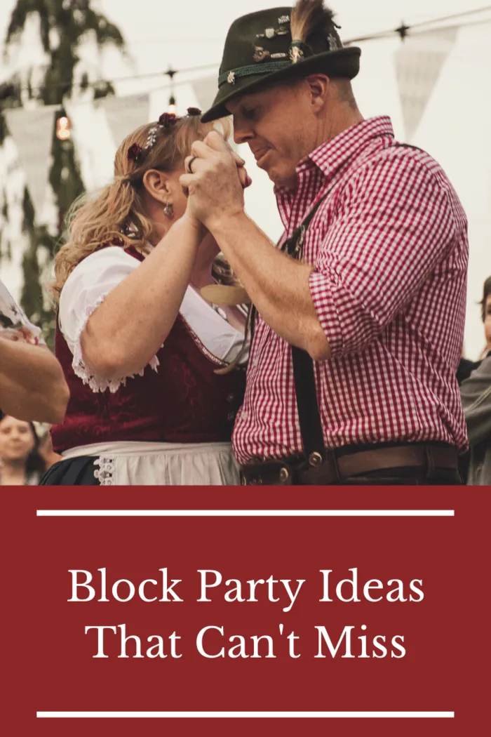 Couple dancing in traditional attire at a block party