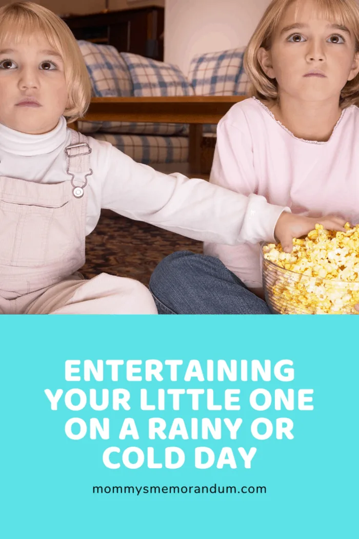 siblings watching videos while snacking on popcorn