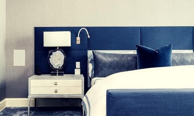 navy headboard and footboard of bed with white duvet