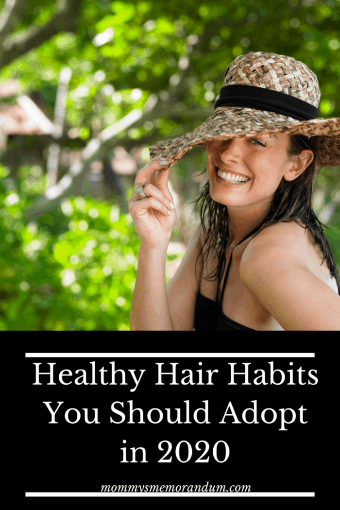 beautiful woman outside with hat on to keep hair healthy