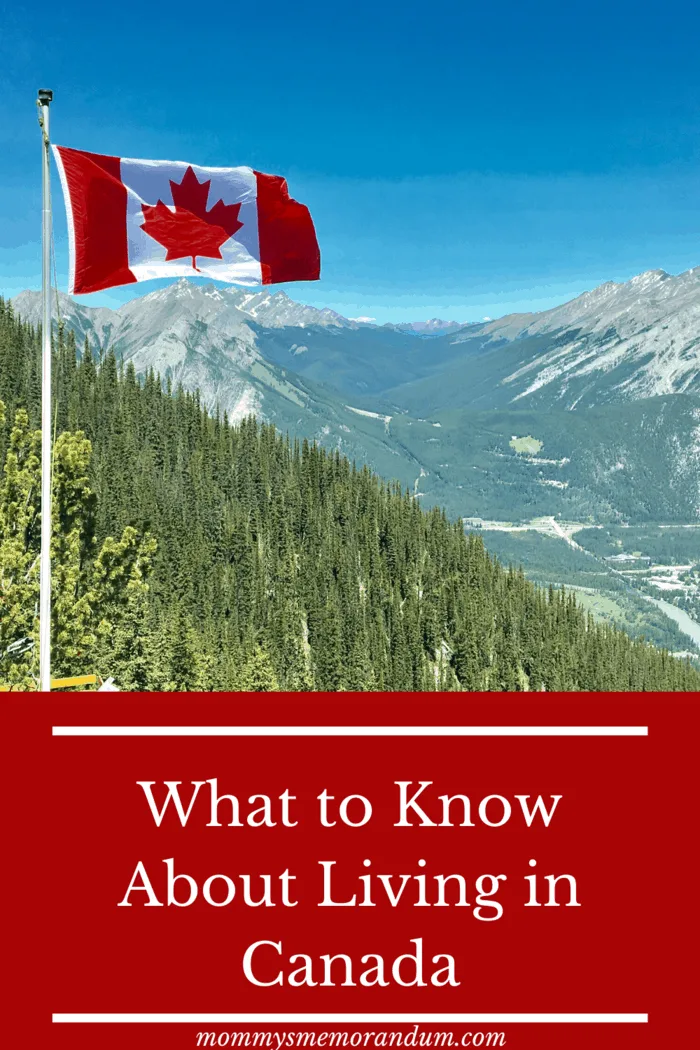 canada flag flying with mountains in the background