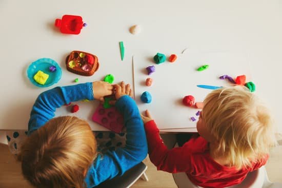 two children playing with playdough for entertainment