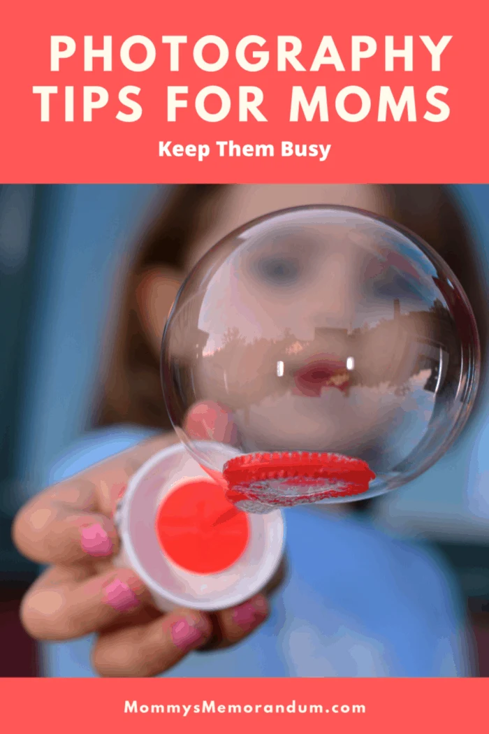 close up of child holding bubble on bubble wand