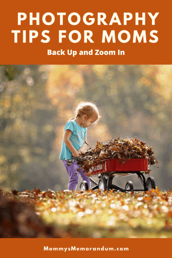 child gathering leaves in wagon in focus background blurred