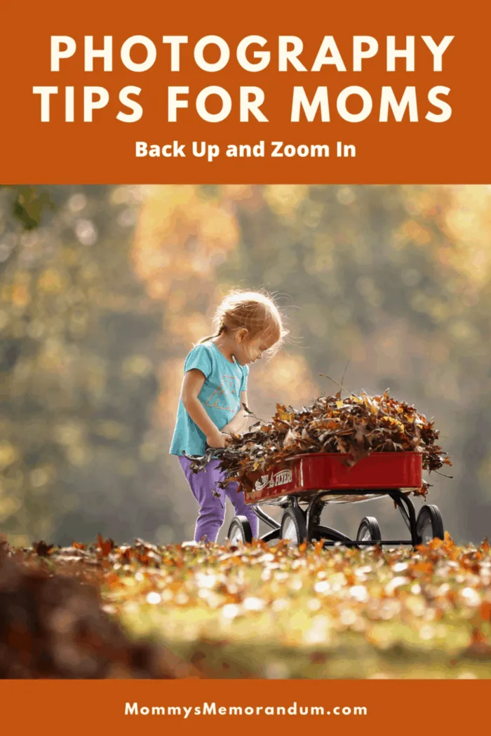 child gathering leaves in wagon in focus background blurred