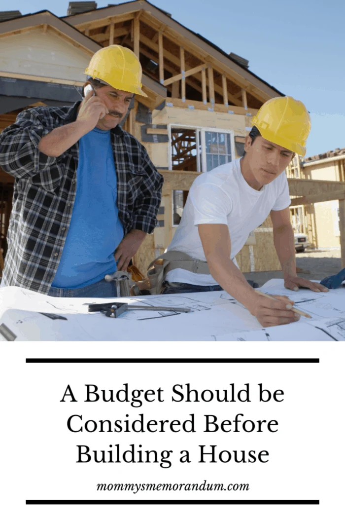 construction workers with contractor on phone