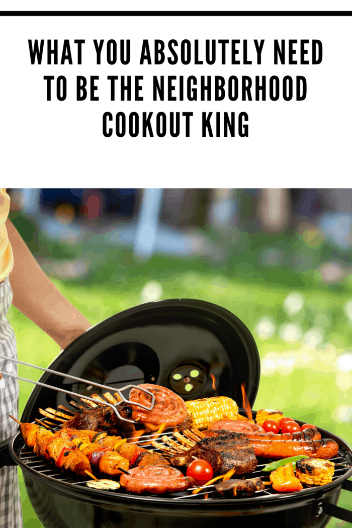 charcoal grill with grill master holding lid and checking on meats