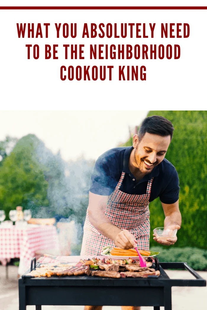 Smiling man seasoning meat on the grill