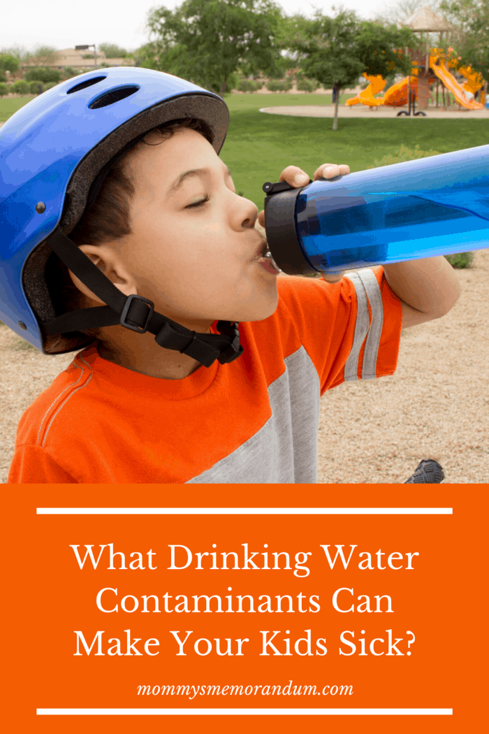 boy with bike helmet on and orange shirt drinking water from blue water bottle free of drinking water contaminants