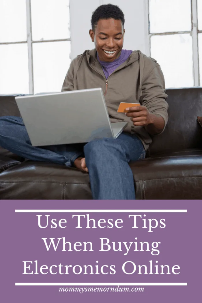 man on couch with laptop and credit card