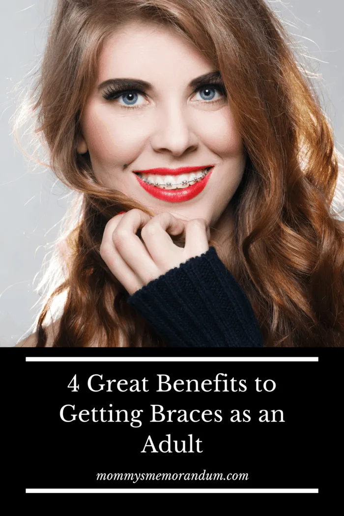 woman in black jacket and red lips showing off getting braces as an adult