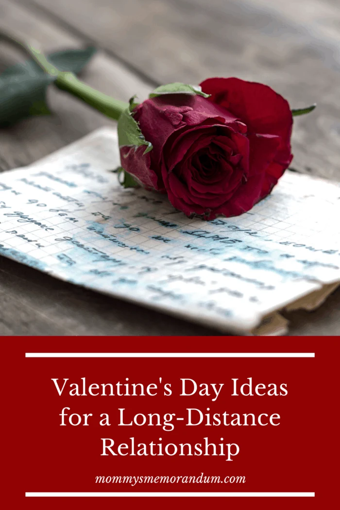 handwritten love letter with single red rose resting on top of letter