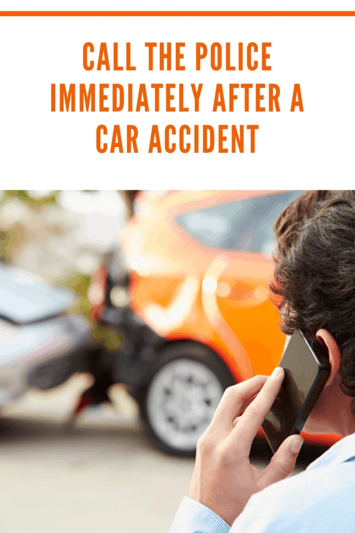 person at accident scene using cell phone to call police