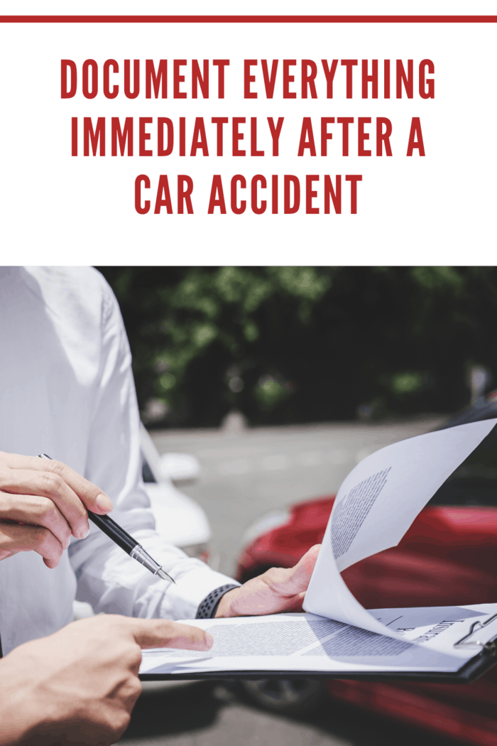 person involved in a car accident filling out report at accident scene