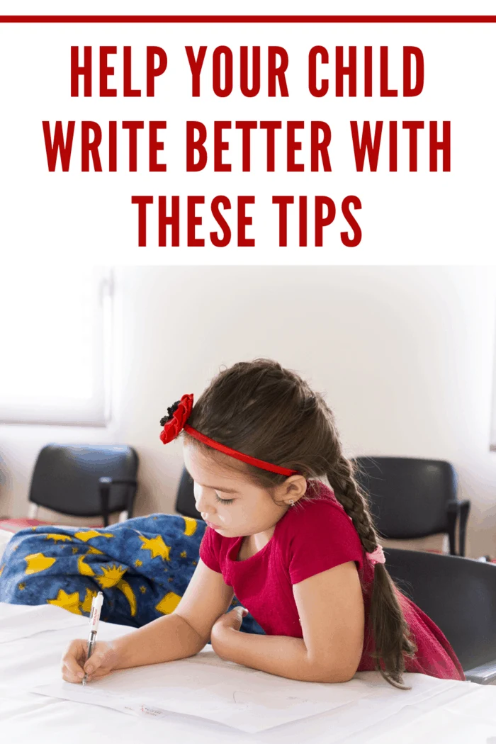 little girl in red writing on paper