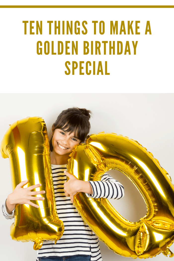 A young girl holding golden number balloons, celebrating her special golden birthday with a big smile.